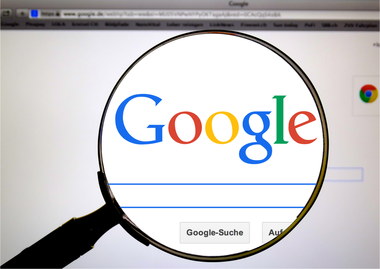 Google logo viewed with a magnifying glass 
