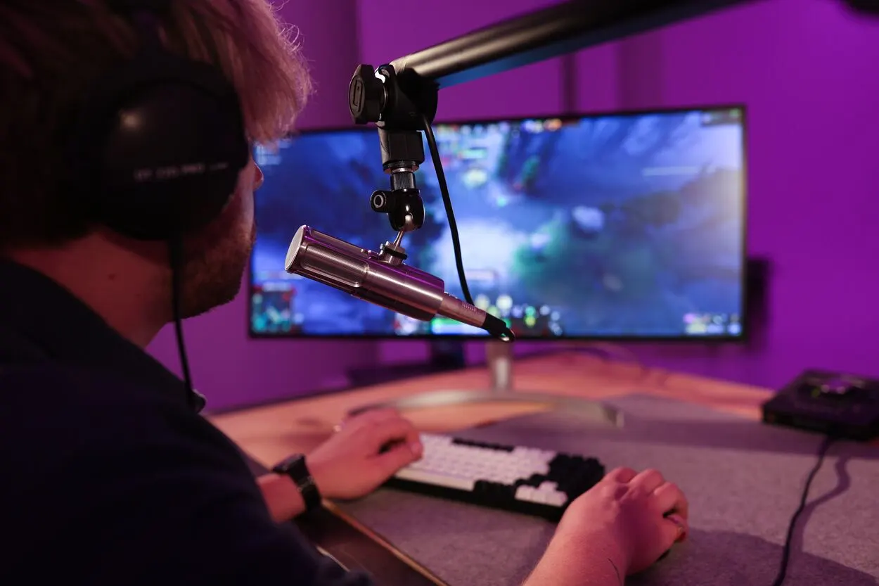 A man wearing headphones and playing video games.